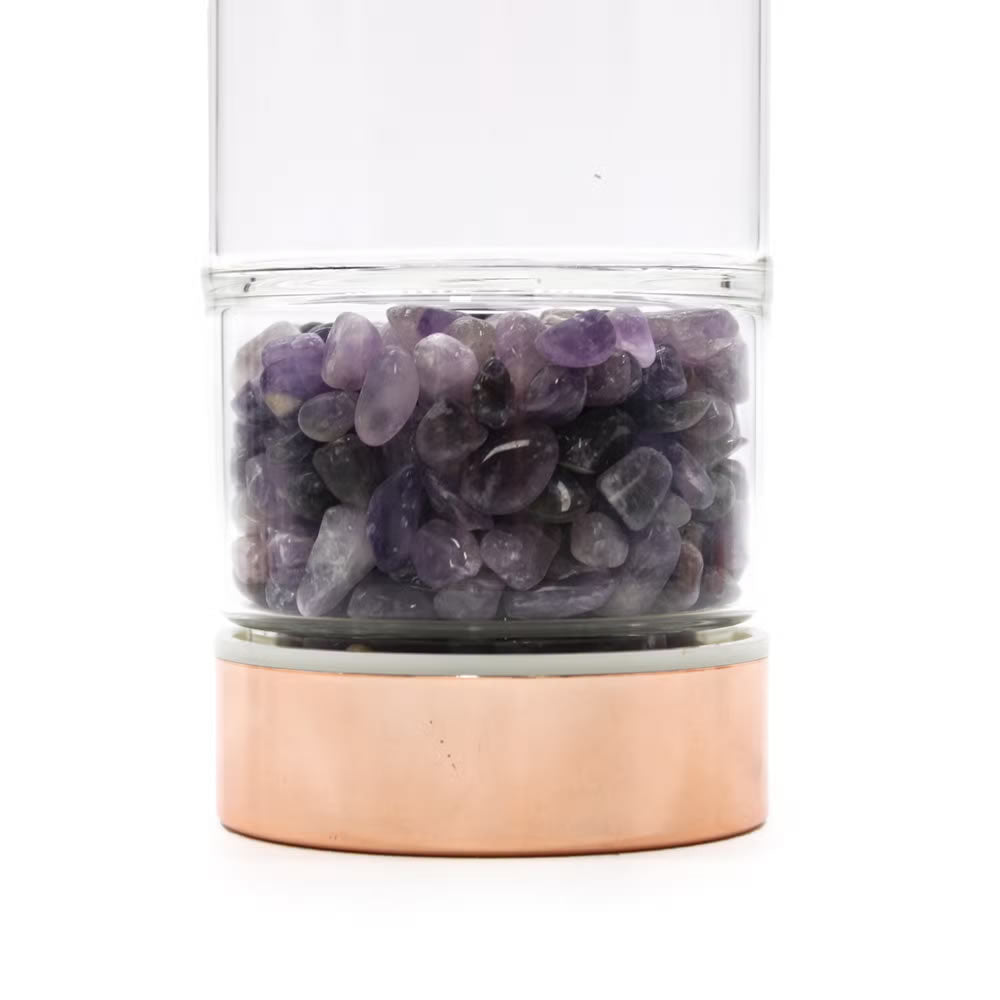 Glass container with purple stones on a white background