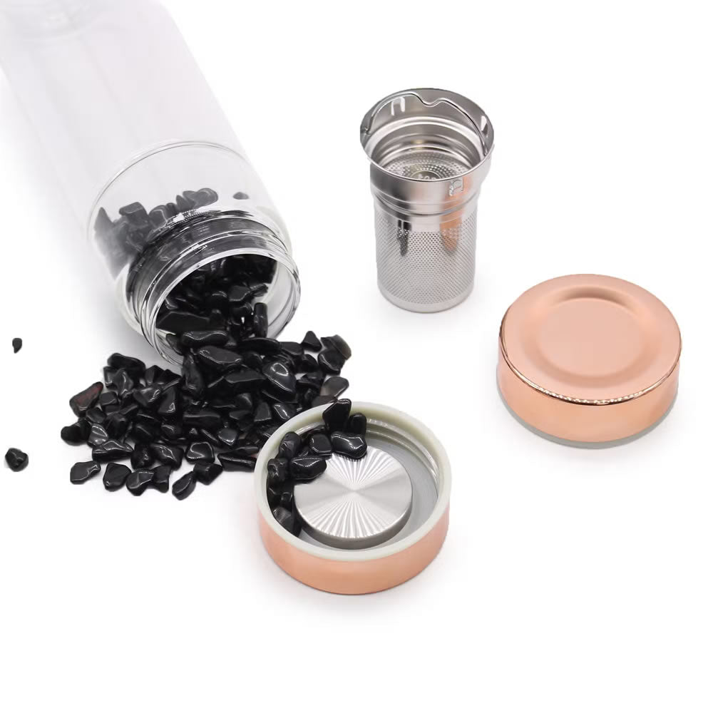 Tea infuser with black tea leaves on a white background