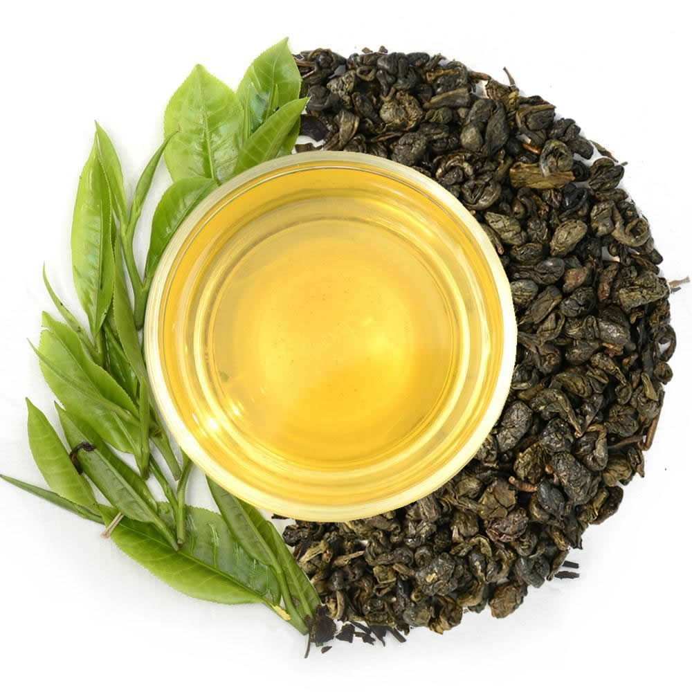 Pure Ceylon Gunpowder Green Tea leaves, a cup of tea, and green leaves - www.ceylonteabox.com