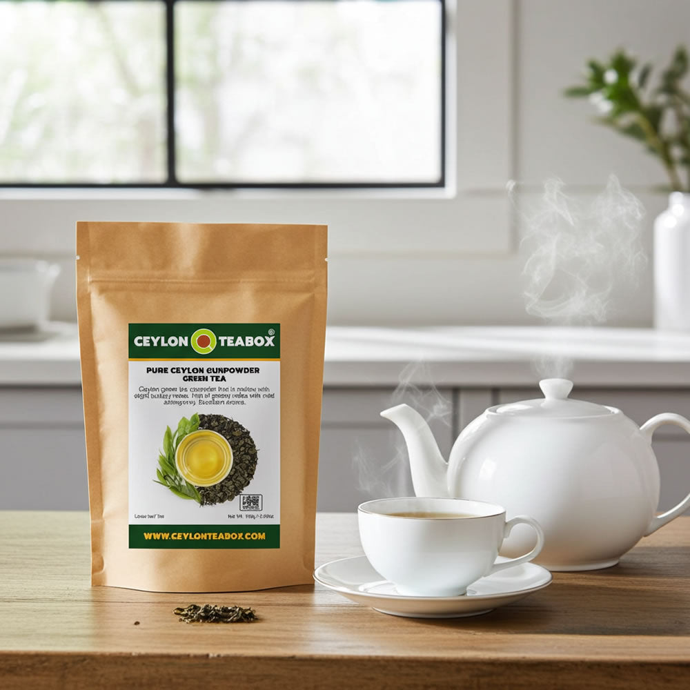 Ceylon Teabox Pure Ceylon Gunpowder Green Tea package with a cup of tea and a teapot on a wooden table.