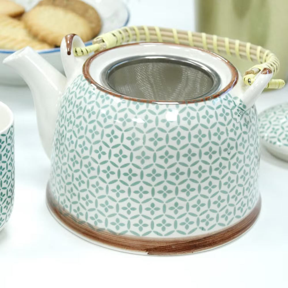 Ceramic teapot with geometric pattern on a white background