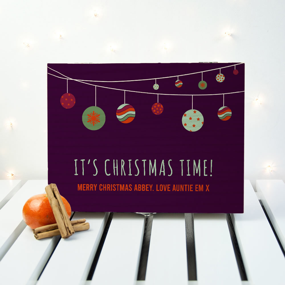 Christmas card with festive decorations on a white surface with lights.