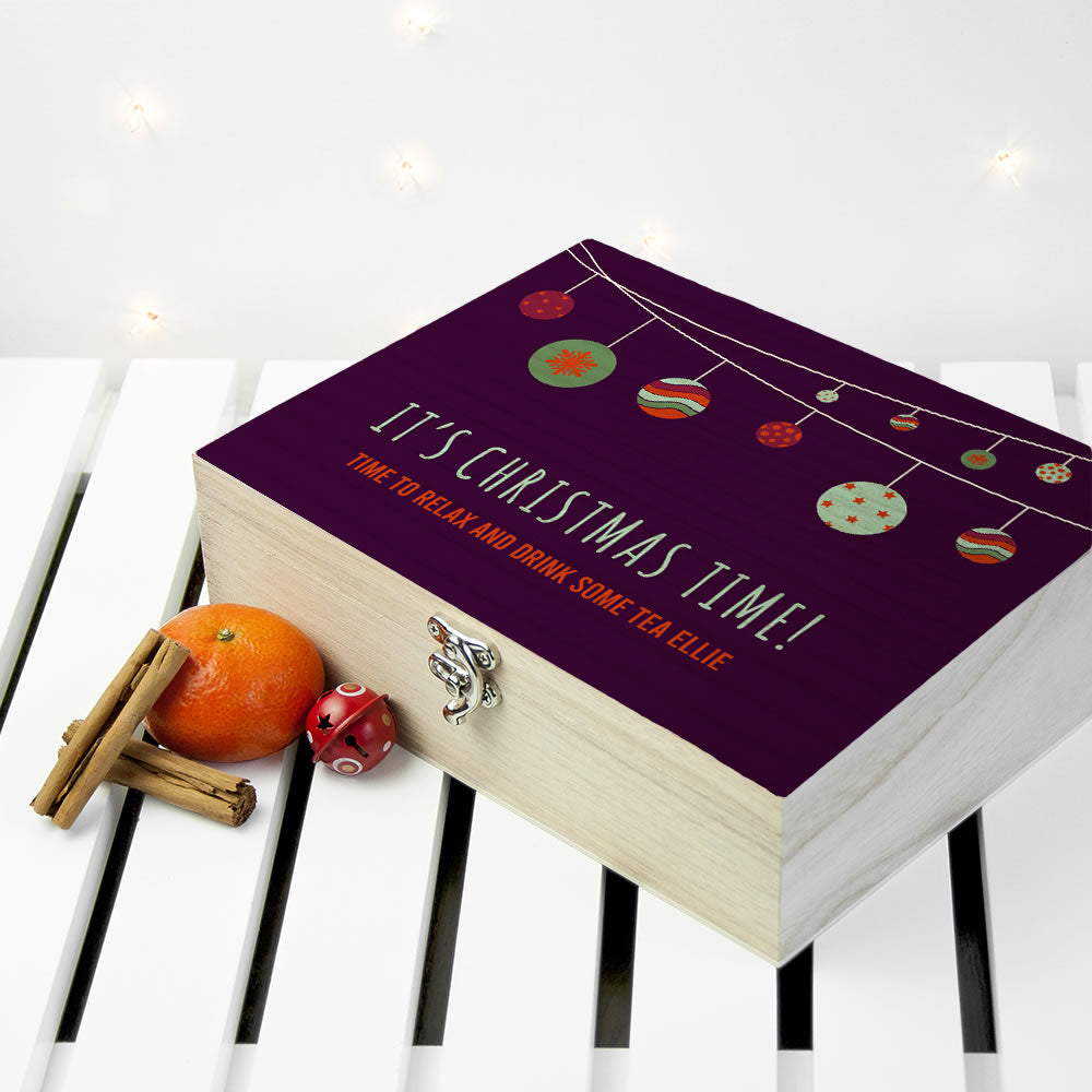 Wooden box with a purple lid featuring Christmas-themed text and decorations on a white background.