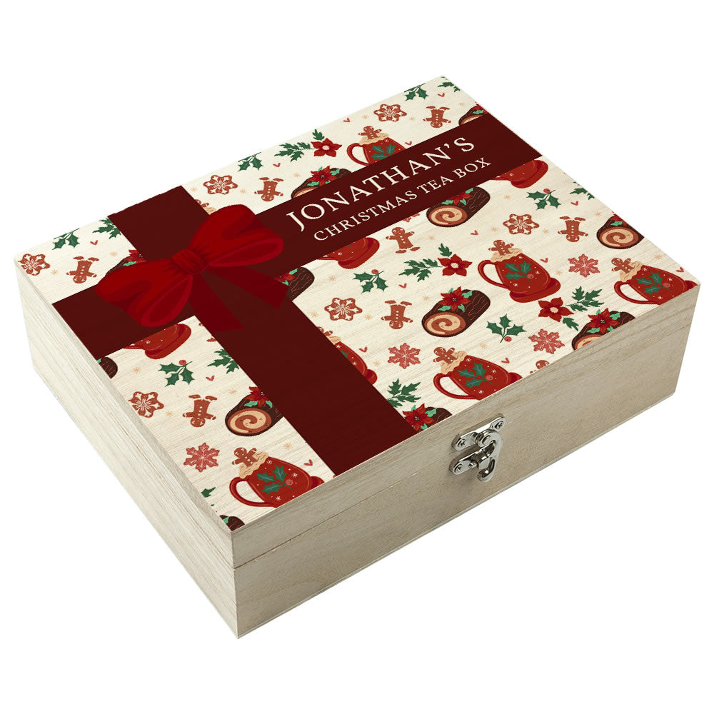 Christmas-themed tea box with decorative patterns and a red ribbon on a white background