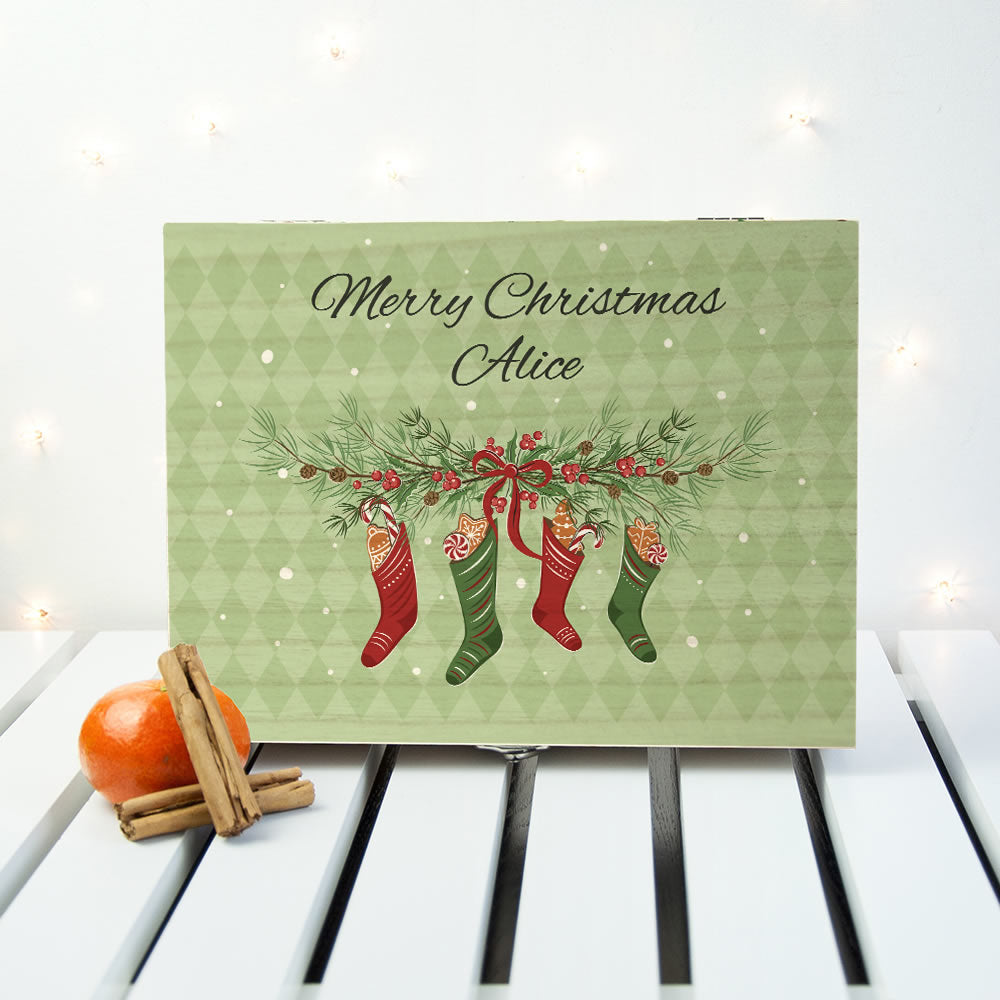 Christmas card with stockings and personalized text on a decorative surface.