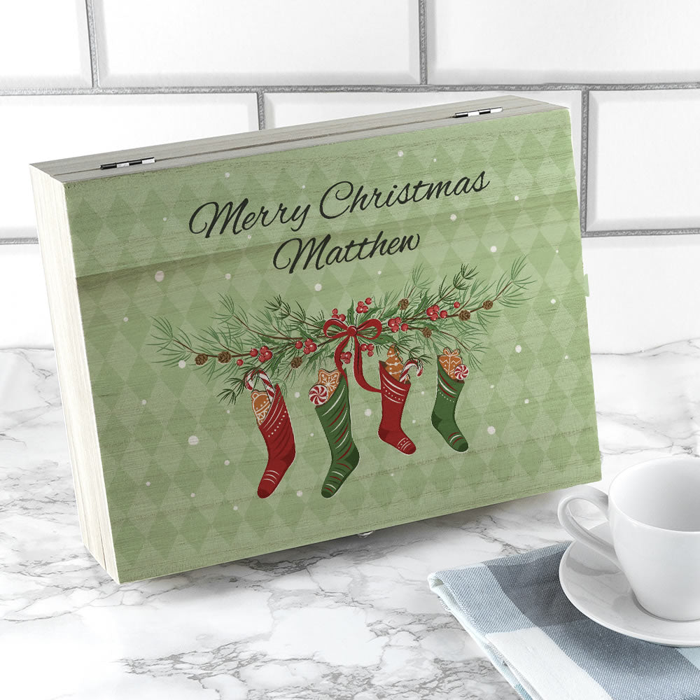 Personalised Christmas gift box with stockings design on a marble surface.