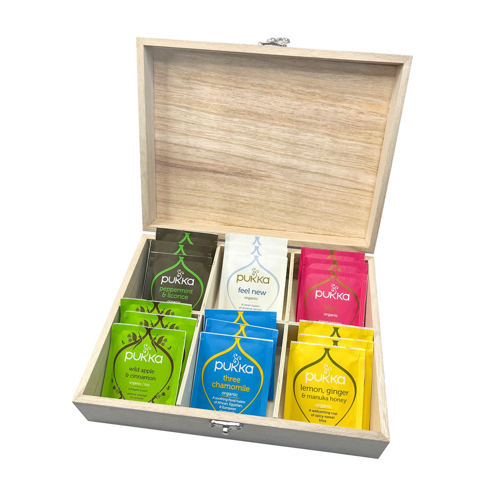 Wooden box with Pukka tea bags inside on a white background