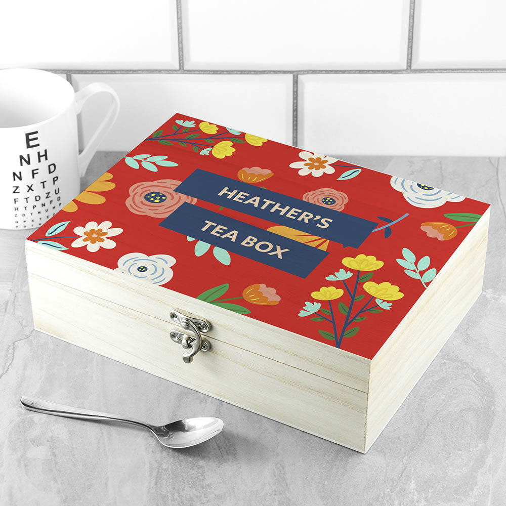 Personalized tea box with floral design and 'Heather's Tea Box' text on a tiled background.