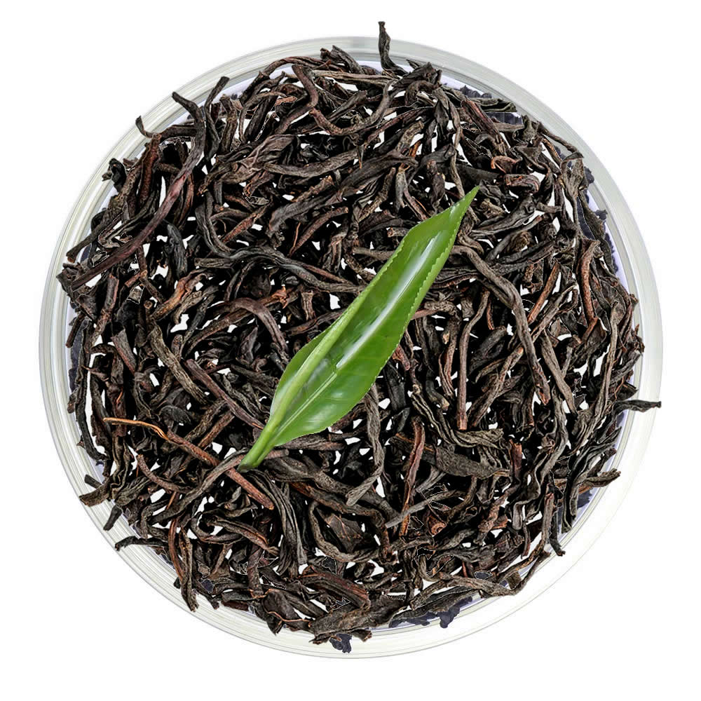 Pure Ceylon Orange Pekoe (OP) Black Tea leaves with a green leaf - www.ceylonteabox.com
