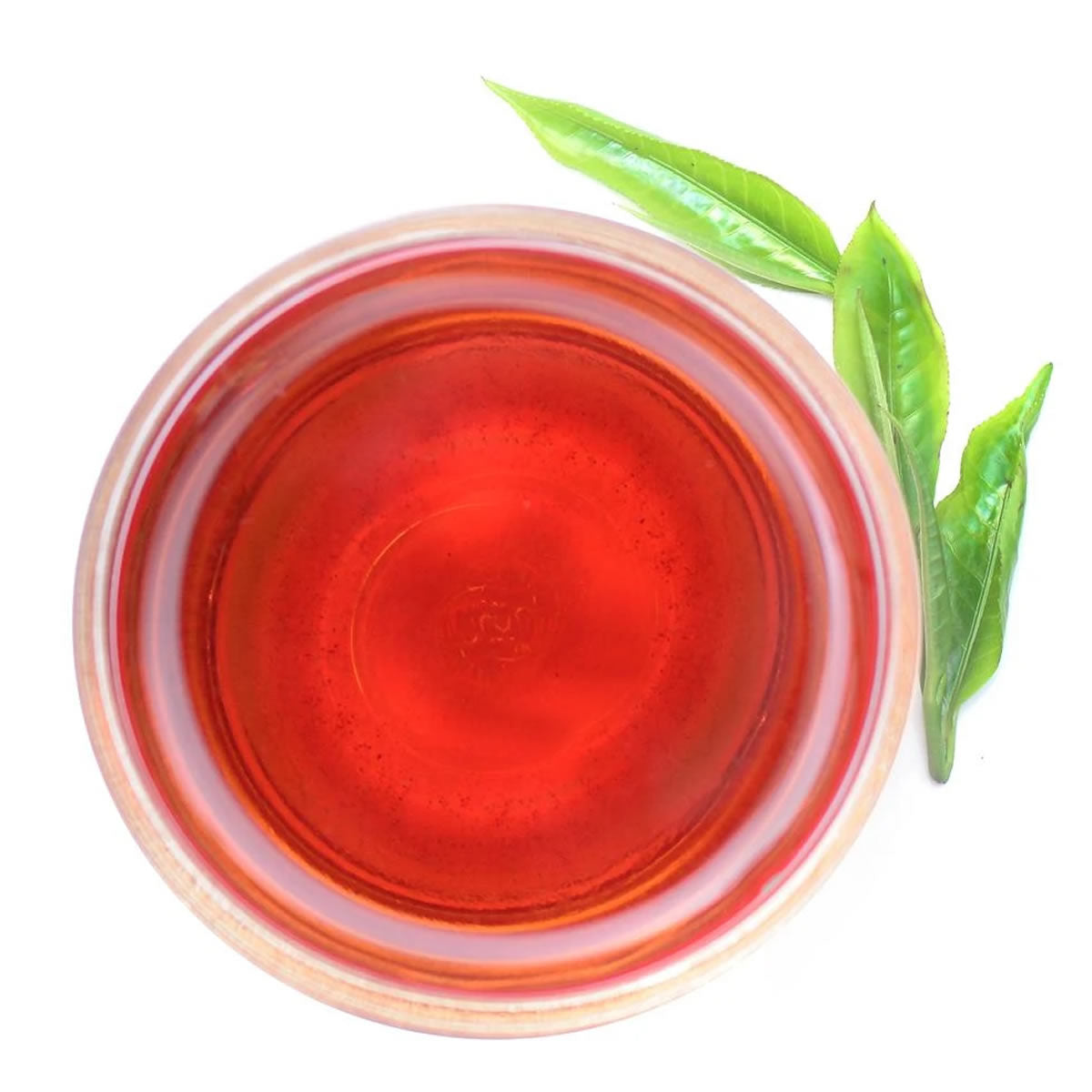 Pure Ceylon Orange Pekoe (OP) Black Tea cup with red liquid and two green tea leaves - www.ceylonteabox.com