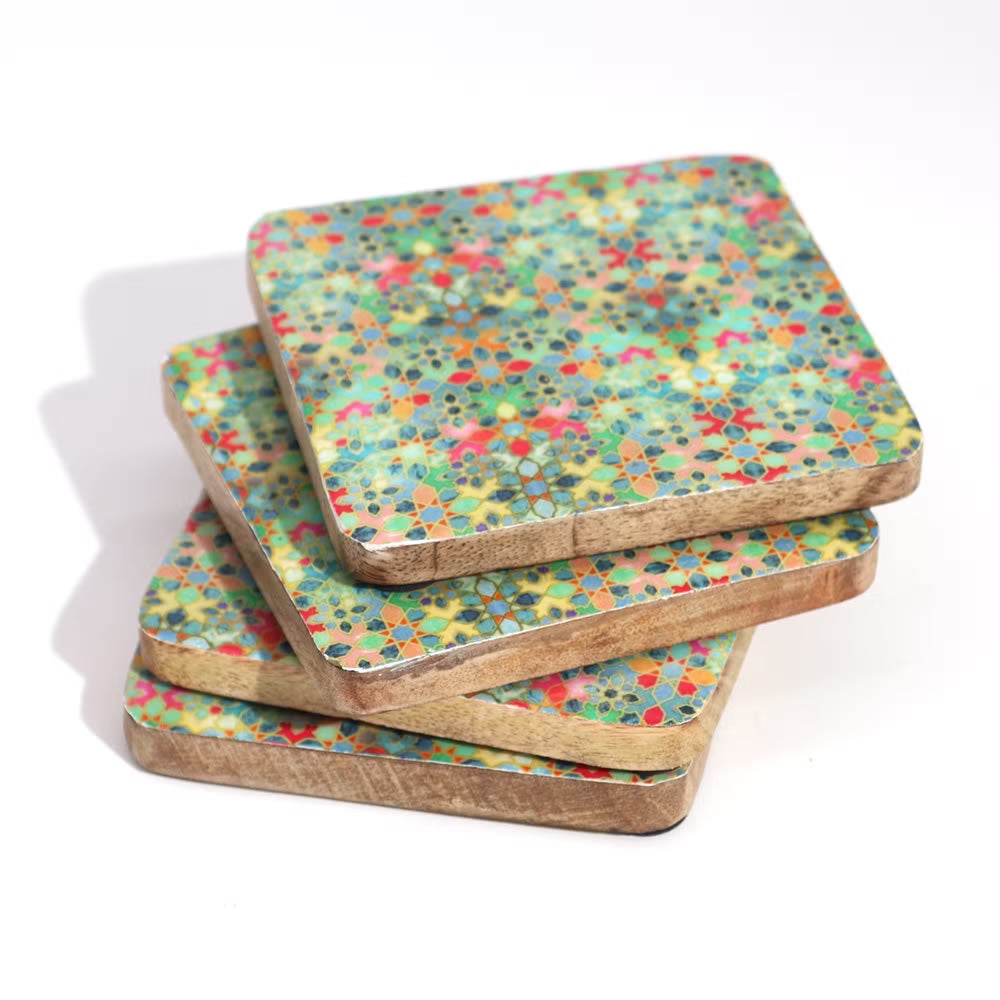 Set of four colorful patterned coasters on a white background